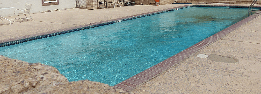 The large in-ground pool at Circle S Campground on a bright day